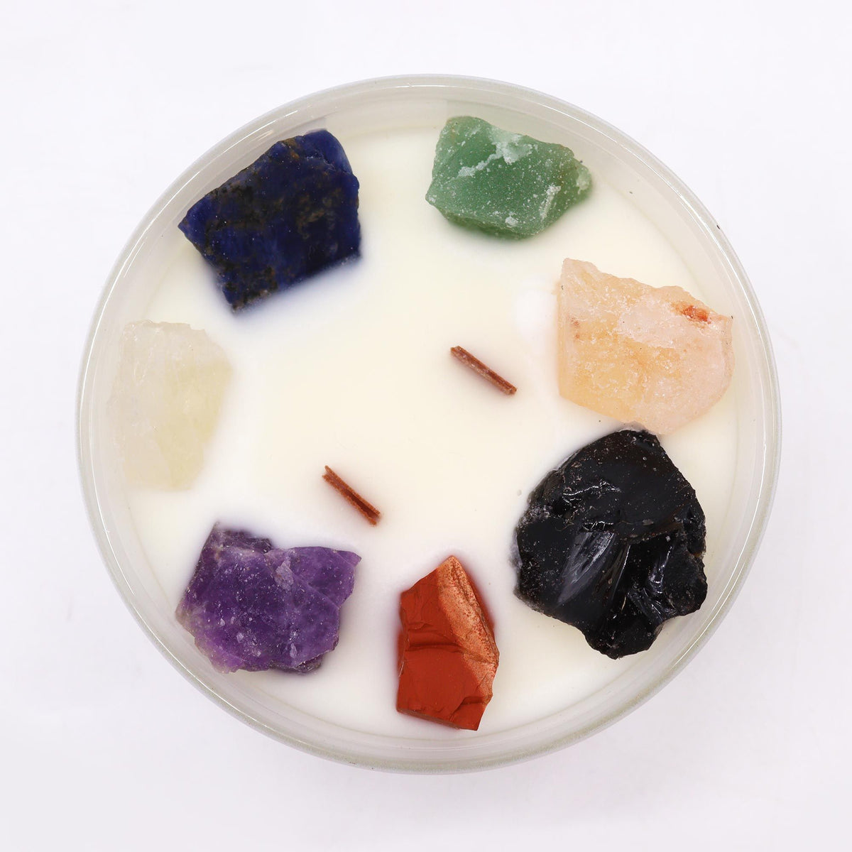 Chakra crystal candle decorated with seven healing gemstones