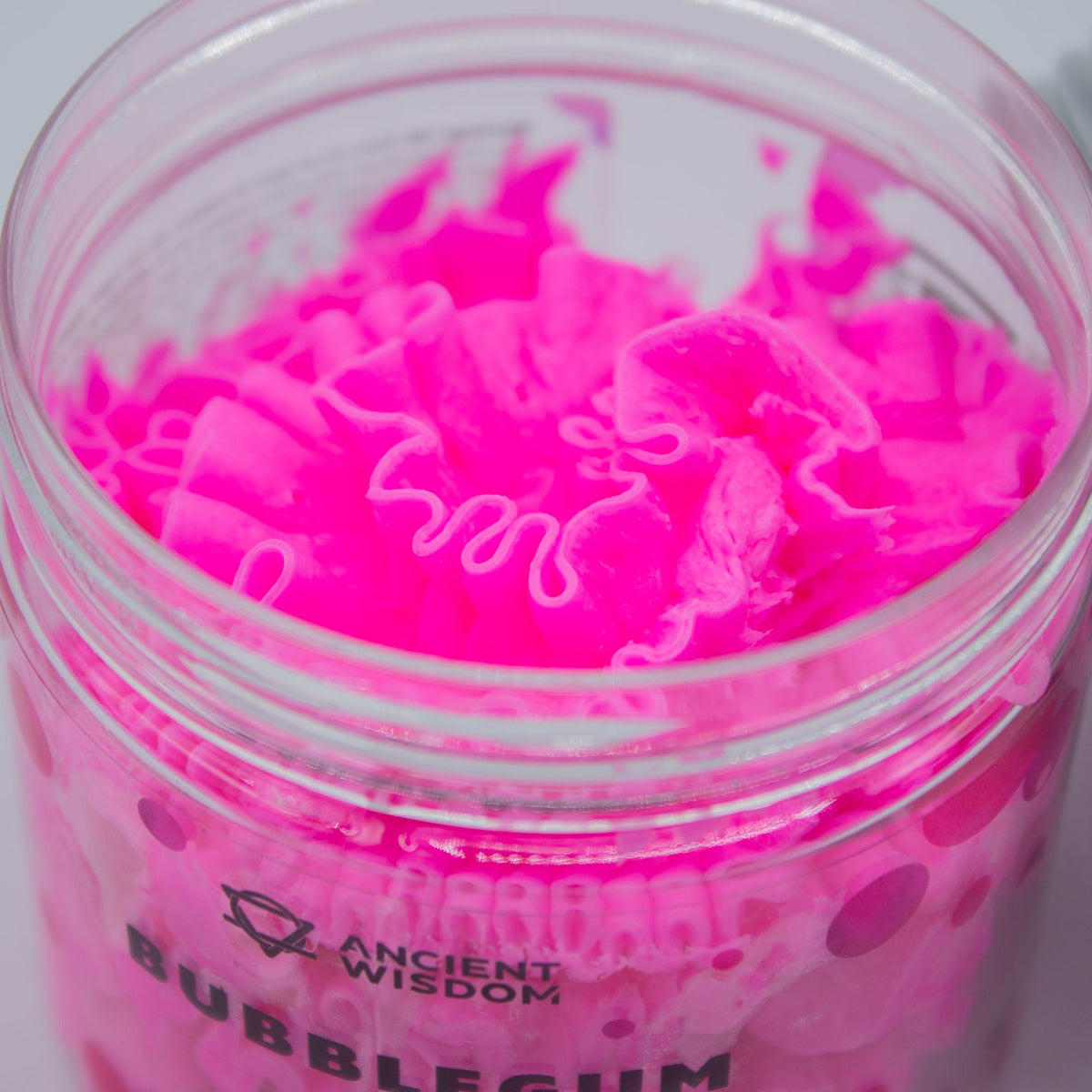 Jar of pink whipped soap with 'Ancient Wisdom' branding on a white background