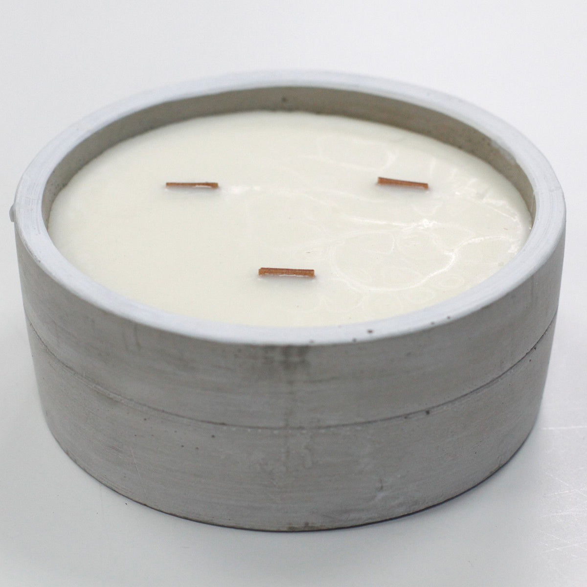 Large round concrete candle with warm patchouli amber fragrance