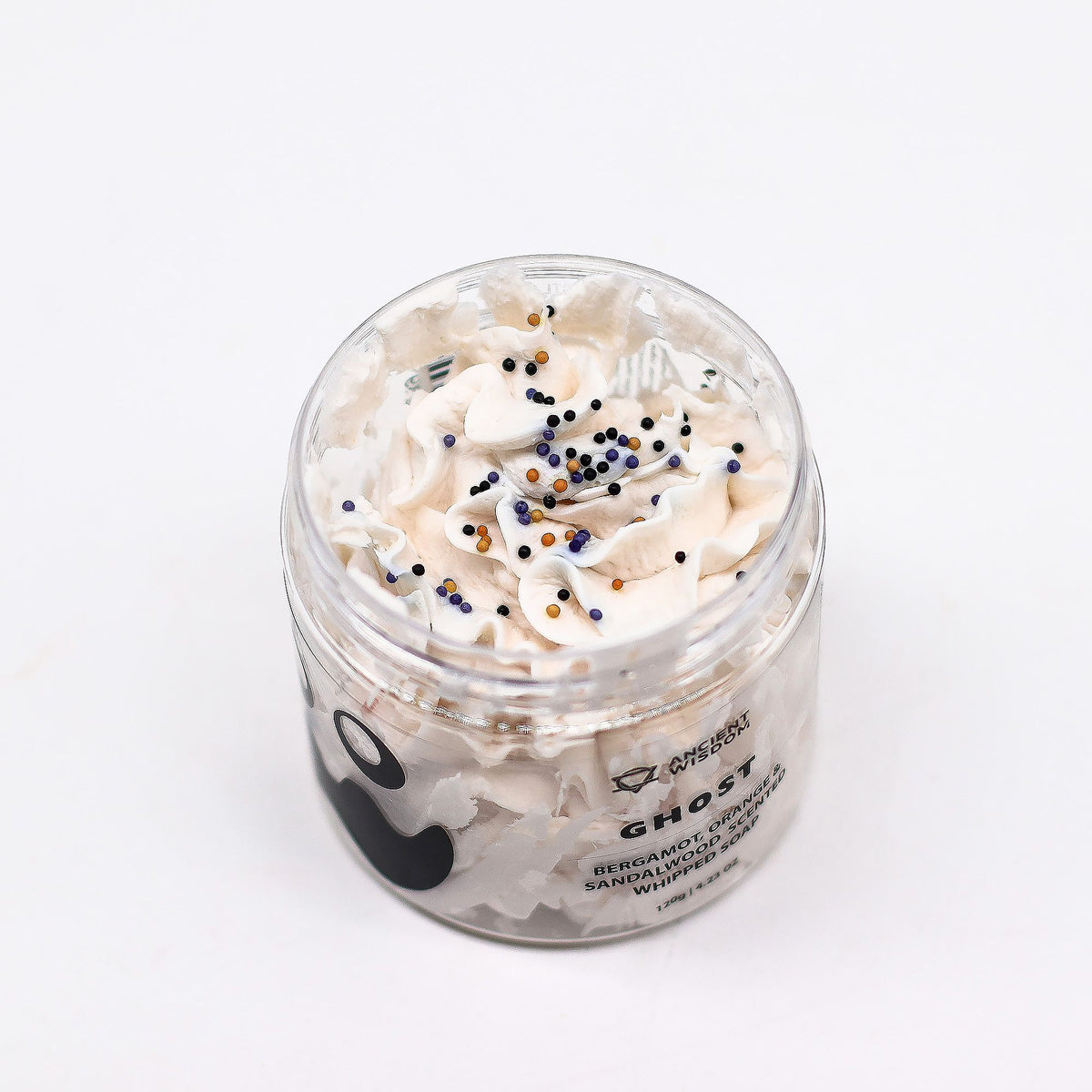 Jar of whipped cream with sprinkles on a white background