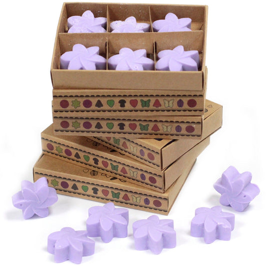Purple flower-shaped wax melts in a cardboard box with decorative patterns on a white background