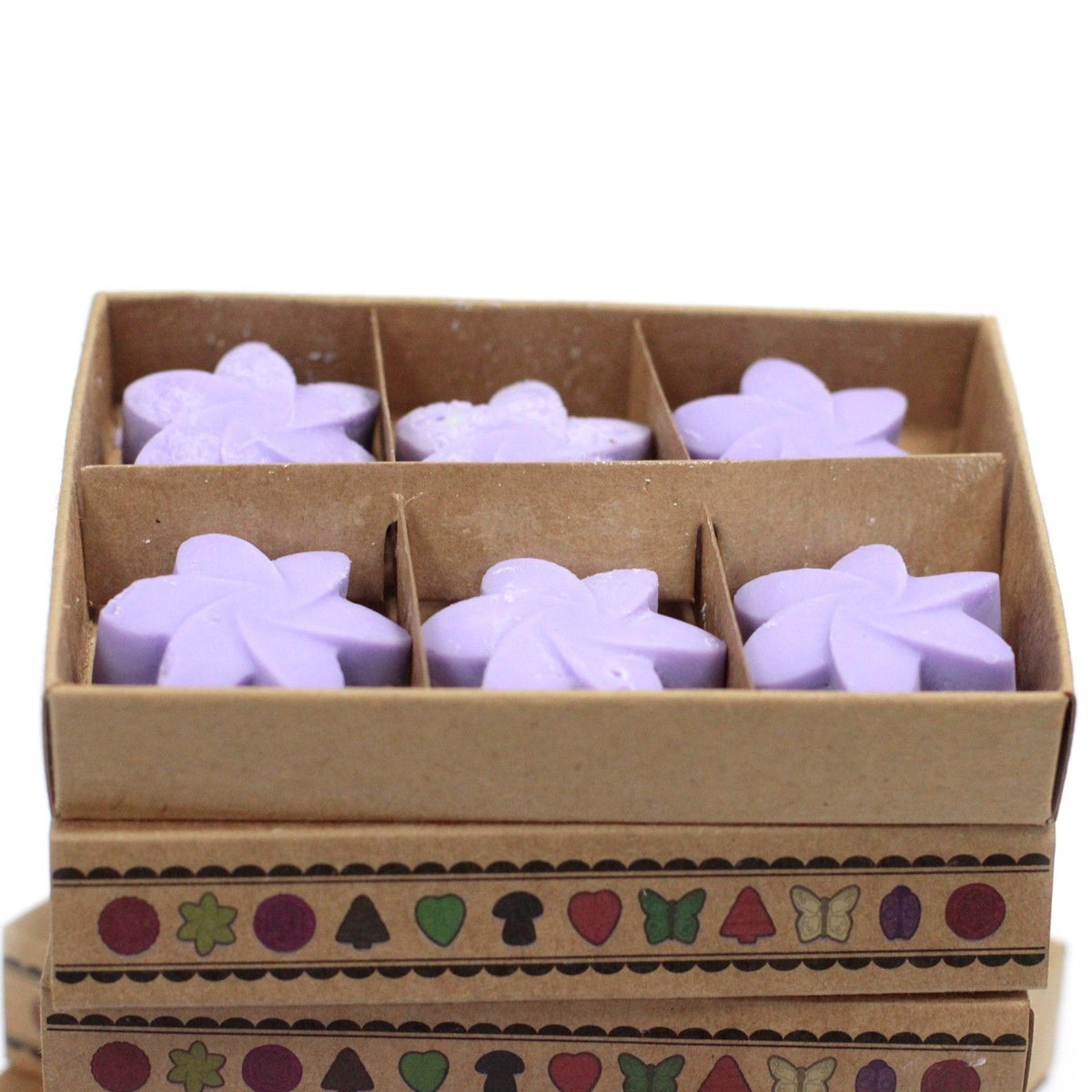 Box of purple star-shaped wax melts with decorative patterns on a white background