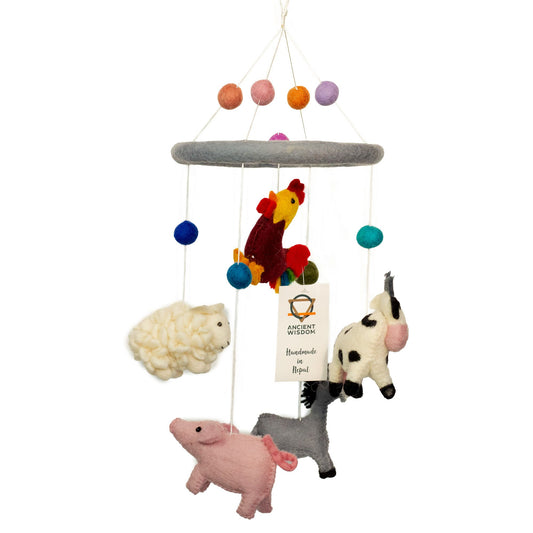 Children's mobile with hanging farm animal toys on a white background